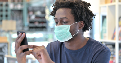 Student with Facemask Using Phone