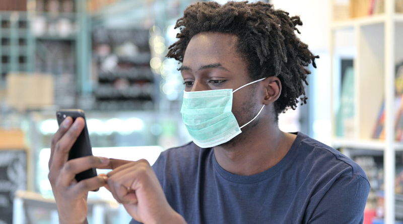 Student with Facemask Using Phone